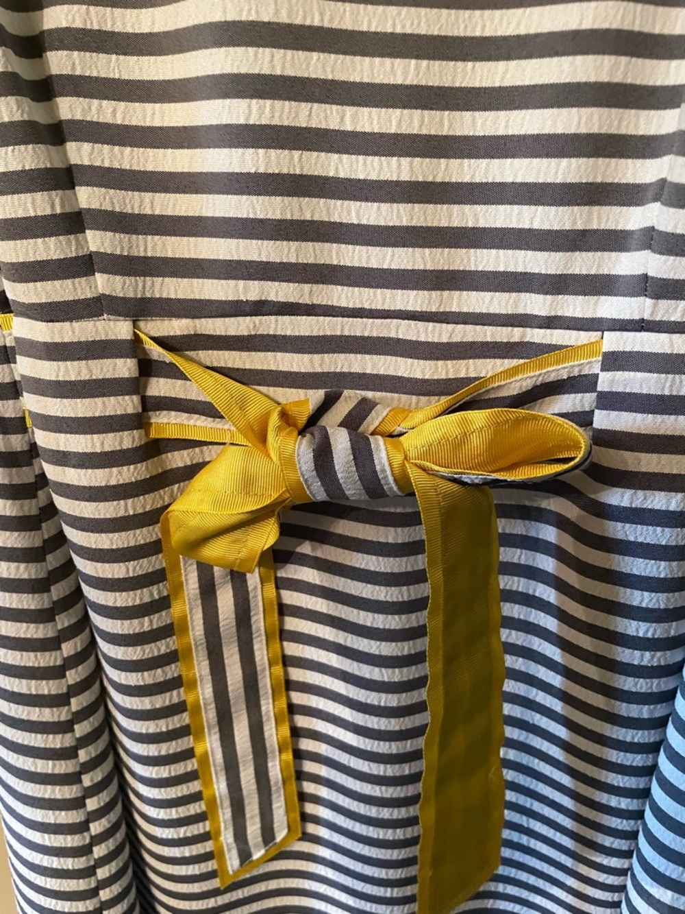 Sleeveless lined  Dress with Yellow trim and gray and white stripes.